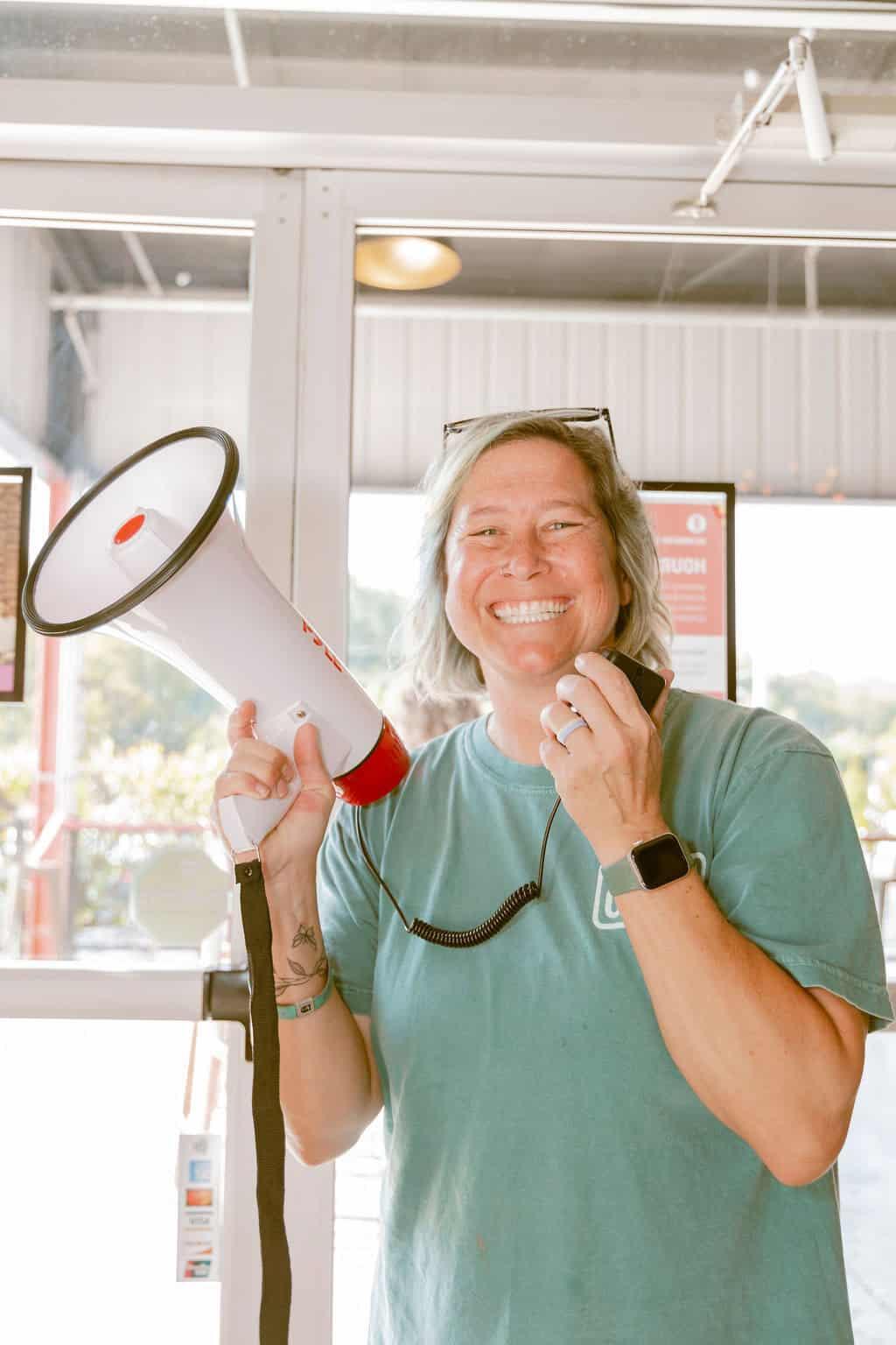 A guest laughing with a megaphone at Camp Reformation